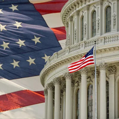 Capitol Building dome with an American flag in the background in Washington DC