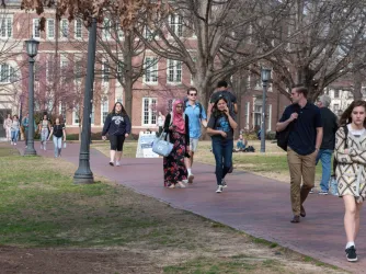 College students walk across the campus of UNC-Chapel Hill.