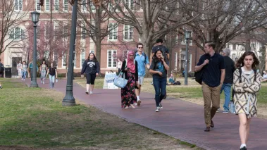 College students walk across the campus of UNC-Chapel Hill.