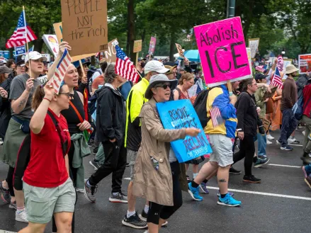 Protest in Center City, Philadelphia, with one person holding a pink sign that reads "Abolish Ice". Photo by Alejandro Diaz Manrique for Shutterstock.com