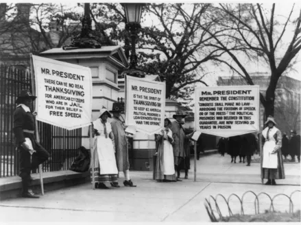 Protesters dressed as pilgrims carry signs calling for amnesty for political prisoners standing in front of the White House, circa 1918.