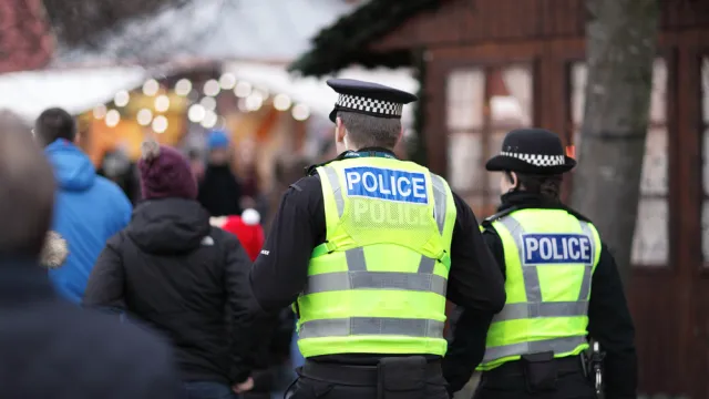 Police in hi-visibility jackets policing crowd control at a UK event