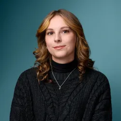 Headshot of Sheridan Macy